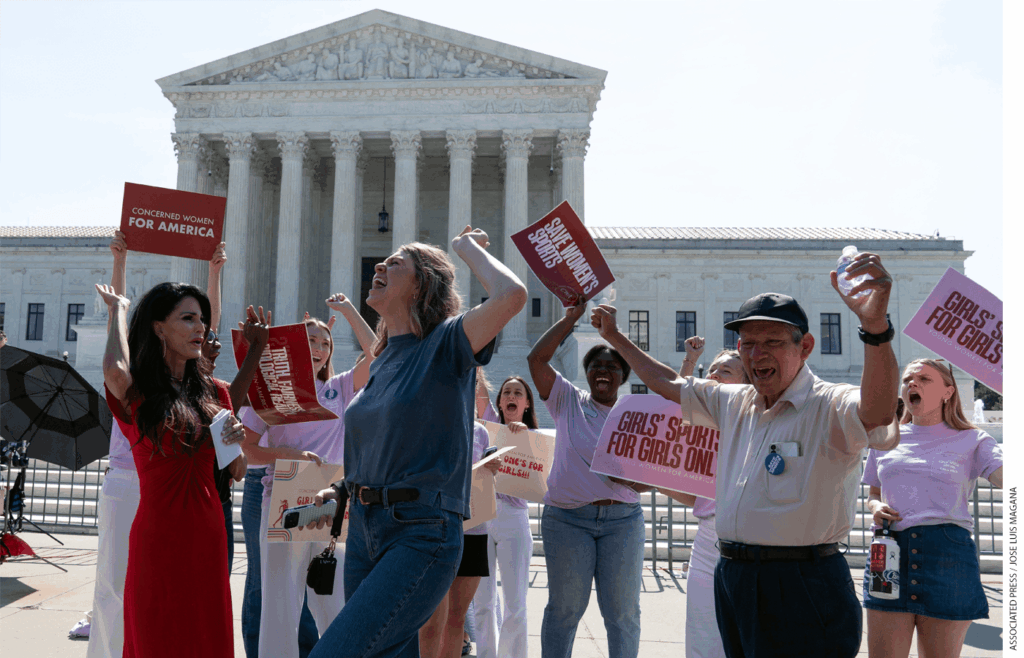 A group of people holding signs and celebrating in front of the U.S. Supreme Court building.