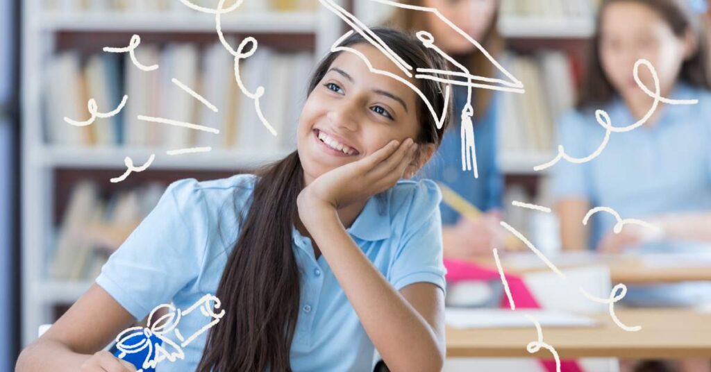 Middle school girl day dreaming at her desk. A graduation cap and diploma are drawn on her.