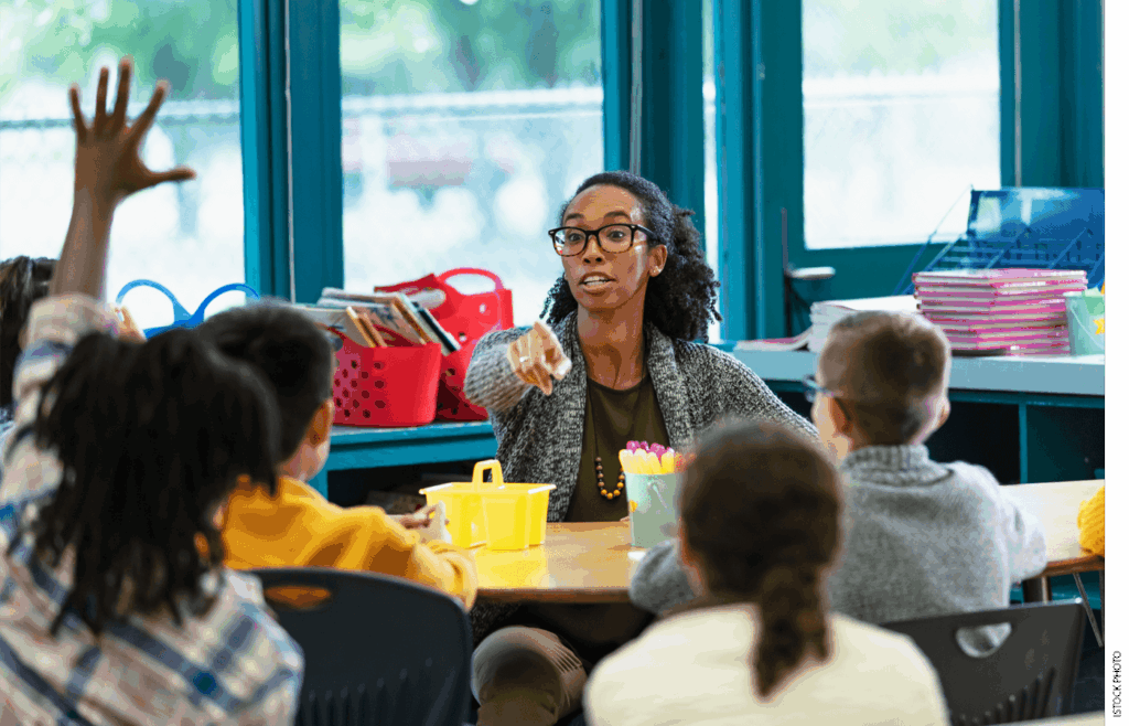 A teacher acknowledges a student in class