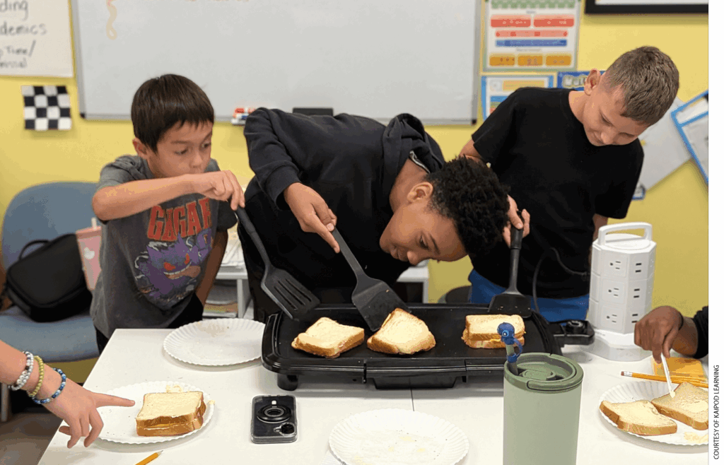 A group of boys practice making grilled cheese sandwiches at a KaiPod learning center in Surprise, Arizona.