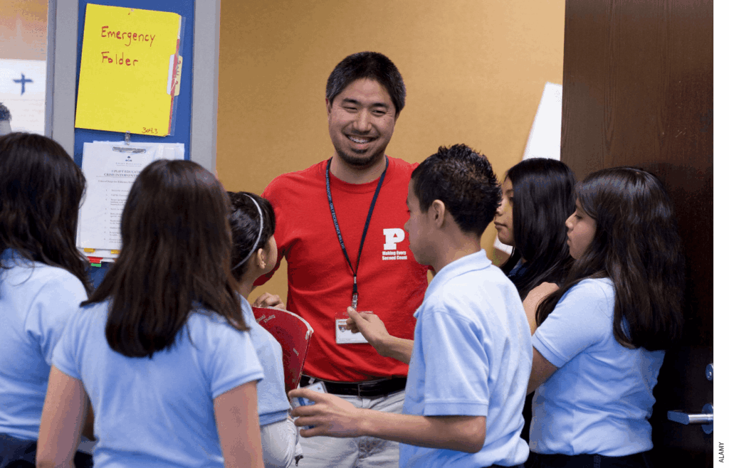A teacher at Peak Preparatory Academy, a charter school in Dallas, laughs with his 7th-grade Spanish students.