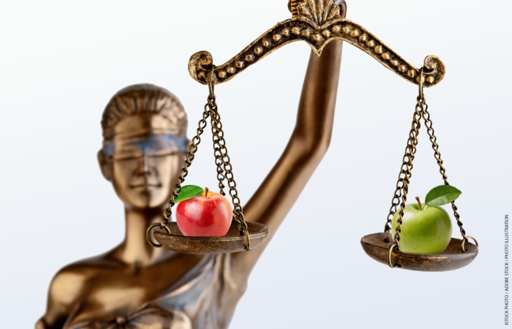 The scales of justice holding an apple in each scale