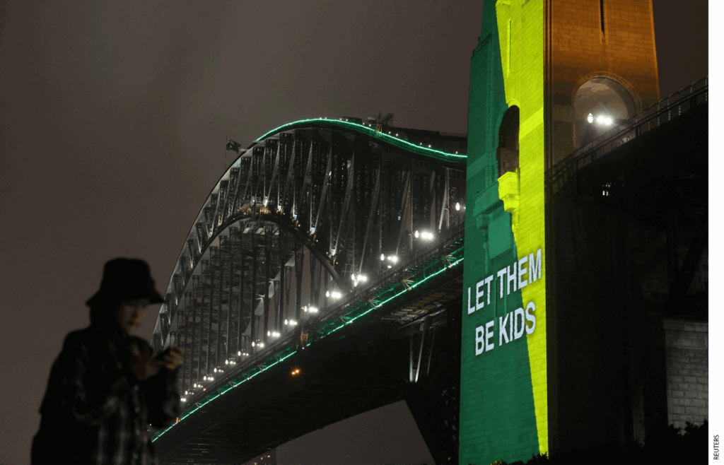 The phrase "Let them be kids" projected on the Sydney Harbour Bridge